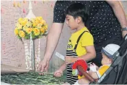  ??  ?? PRAYERS FOR THE DEAD: Residents attend a merit-making ceremony yesterday. People also went to Terminal 21, scene of the mass-shooting on Feb 8, to place flowers for those killed.