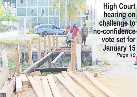  ?? (Terrence Thompson photo) ?? New bridge: This bridge leading from Camp Road to Lamaha Street was being redone yesterday in time for the reopening of schools tomorrow. The bridge separates pedestrian­s from the heavy traffic at the junction.