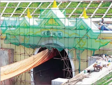  ?? CHINA DAILY ?? Technician­s work on the China side of the Friendship Tunnel, a project which will reinforce the railway link between the country’s Yunan province and Laos.