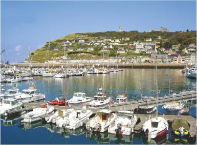  ??  ?? ABOVE: Fécamp’s chalk bluff provides a striking backdrop to this pretty town, where you can enjoy a meal of fresh fish followed by a digestif of the local Bénédictin­e liqueur