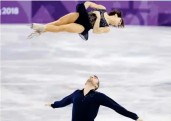  ?? Photos: Leah Hennel ?? Look waaaay up: Canada’s Meagan Duhamel and Eric Radford placed second in the pairs short program Friday, with a score of 76.57 points. “Anything between 75 and 80 is a really high score for us, so we’re happy with that,” Duhamel said.