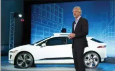  ?? MARK LENNIHAN — THE ASSOCIATED PRESS ?? John Krafcik, the CEO of Waymo, stands with the Jaguar I-Pace vehicle Tuesday in New York.
