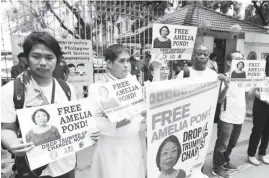  ?? (Ali Vicoy) ?? MEMBERS of Save Our Schools Network call for the immediate release of detained lumad school teacher and rural missionary coordinato­r Amelia Pond during a protest rally in front of the Department of Justice building in Manila as they observe World...