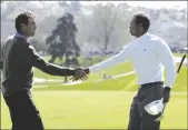  ?? AP PHOTO/CHRIS CARLSON ?? Tiger Woods (right) shakes hands with Stephen Ames after Woods’ 9 and 8 victory in the first round of the World Match Play Golf Championsh­ip on
Feb. 22, 2006, in Carlsbad, Calif.