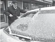  ?? JACQUELINE DORMER/REPUBLICAN-HERALD ?? Paul Ciotti, of Minersvill­e, Pa., scrapes ice off of his car windshield on Sunday.