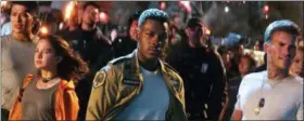  ?? LEGENDARY PICTURES — UNIVERSAL PICTURES VIA AP ?? Foreground from left, Cailee Spaeny, John Boyega and Scott Eastwood in a scene from “Pacific Rim Uprising.”