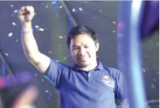  ?? — AFP file photo ?? Pacquiao raising a clinched fist during a campaign rally in General Santos City, on the southern island of Mindanao on May 7.