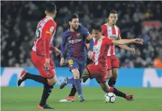  ??  ?? Plans have been mooted for Lionel Messi’s Barcelona side and Girona, in red, to play the first La Liga match outside Spain AFP