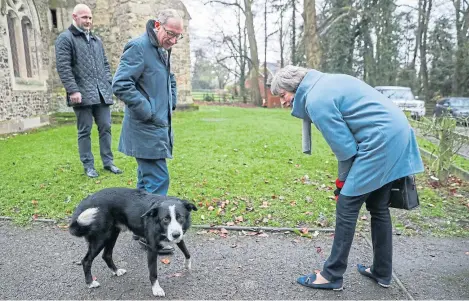  ?? Picture: PA. ?? Theresa May and husband Philip meet a border collie named Blitz, after a church service yesterday.