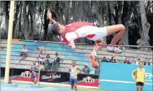  ??  ?? UP AND OVER: Alexander Road’s Sachin Morris clears the bar during the U15 boys’ high jump event