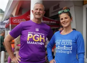  ?? Sebastian Foltz/Post-Gazette ?? Rick Raeder of Rogue Runners and Kim Lambert of the City of Bridges Run Club at the Gingerbrea­d Man Running Company store in Shadyside April 17, prior to City of Bridges club running night.