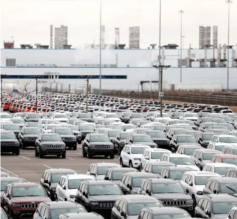  ?? CARLOS OSORIO/ THE ASSOCIATED PRESS ?? Jeeps are shown parked outside the Jefferson North Assembly Plant in Detroit on Tuesday, the day Fiat Chrysler announced plans for that city’s first new auto assembly plant in a generation, as part of a $4.5 billion manufactur­ing expansion in southeast Michigan.