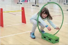  ?? LAURA BARTON THE WELLAND TRIBUNE ?? Alyssa Martin, 5, ducks down to go through the hoop that’s part of an obstacle course set up for Healthy Kids Day at the Niagara Centre YMCA on Sunday.