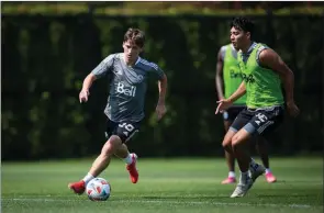  ?? The Canadian Press ?? New Vancouver Whitecaps designated player Ryan Gauld, left, of Scotland controls the ball while being watched by Patrick Metcalfe in Vancouver on Aug. 2.