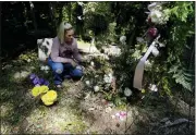  ?? BRYNN ANDERSON — THE ASSOCIATED PRESS ?? Angel Campbell, 37, visits her grandmothe­r’s, Nellie Mae Howard, 82, “Mammaw” grave on Aug. 4, in Chavies, Ky. Howard died in massive flooding.