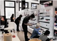  ??  ?? Walgreens’ new San Francisco flagship store in Union Square caters to more foodie-friendly tastes with self-serve frozen yogurt in the Upmarket Cafe, top, and Cafe Madeleine goodies, left. A department store-size cosmetics section, above, features...