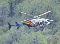  ?? DAVID KADLUBOWSK­I/THE REPUBLIC ?? An Arizona Department of Public Safety helicopter joins Sunday’s search for victims of Saturday’s flash flood in the Payson area.