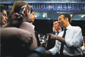  ?? Jacquelyn Martin / Associated Press ?? French President Emmanuel Macron (right) speaks to students at George Washington University in Washington. “You don’t always have to play by the rules,” he told them.