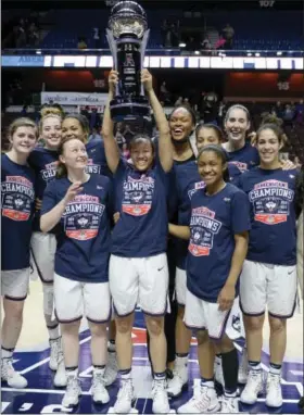  ?? JESSICA HILL - THE ASSOCIATED PRESS ?? The UConn women’s basketball team pose with the American Athletic Conference championsh­ip trophy after defeating South Florida in an NCAA tournament final at Mohegan Sun Arena, Monday, March 6, 2017, in Uncasville, Conn.