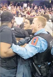  ?? NATION, A11
Scott Olson
Getty I mages ?? POLICE BREAK UP skirmishes between Trump supporters and protesters in Chicago on Friday after his rally was postponed.