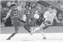  ?? CHRIS YOUNG/AP ?? Orlando City’s Mauricio Pereyra has his shot blocked by Toronto FC’s Ralph Priso during the first half of their MLS match Saturday in Toronto.