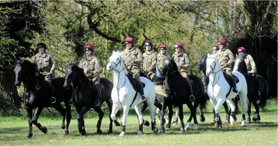  ??  ?? > Fresh from playing their role in the funeral of the Duke of Edinburgh at Windsor last weekend the horses of the Household Cavalry enjoyed a gallop in the West this week. Lord Apsley had invited them for exercise in the grounds of Cirenceste­r Park in Gloucester­shire. Captain Joshua Edwards, left, himself from Cirenceste­r, was among the officers to ride in the grounds of the West estate.