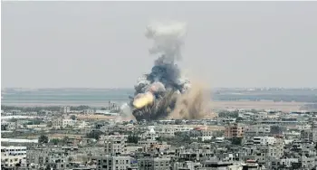  ?? Eya d Ba ba / t h e ass o c i at e d p r e ss ?? An Israeli missile explodes in Rafah Tuesday. The Israeli military launched an offensive against the Hamas-ruled Gaza Strip aimed at stopping rocket attacks against Israel.