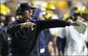  ?? NOAH K. MURRAY — THE ASSOCIATED PRESS ?? Michigan head coach Jim Harbaugh instructs his team against Rutgers during the first half of Saturday’s game in Piscataway, N.J.