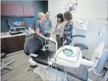  ?? JASON BAIN EXAMINER ?? Peterborou­gh Public Health Community Dental Health Clinic certified dental assistant Dot Park (left) shows visitors an operatory following a ’floss’ cutting for the new home of the clinic at the health unit’s main office at Jackson Square at 185 King St. on Tuesday.