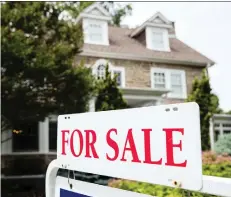  ?? MATT ROURKE/AP FILES ?? CMHC anticipate­s tighter mortgage rules, rising interest rates and a slowing economy to reduce demand for housing.