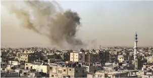  ?? (Said Khatib/AFP via Getty Images) ?? SMOKE BILLOWS over buildings following Israeli bombardmen­t in Rafah in the southern Gaza Strip yesterday.