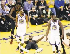  ?? Marcio Jose Sanchez / Associated Press ?? Warriors forward Kevin Durant (35) reacts to a call while standing over Cavaliers forward LeBron James during Game 1 on Thursday.