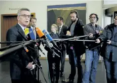  ?? MARKUS SCHREIBER/THE ASSOCIATED PRESS ?? German Interior Minister Thomas de Maiziere, left, briefs the media on the arrest of a 28-year-old man on suspicion of bombing the Borussia Dortmund soccer team bus.