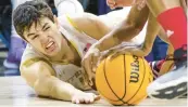  ?? MICHAEL CATERINA/AP ?? Notre Dame’s Cormac Ryan reaches for a loose ball during the second half on Saturday.