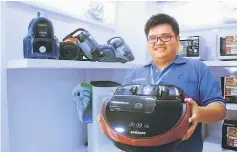  ??  ?? Siong How marketing executive Jong Sieng Chung promotes a Samsung vacuum cleaner.