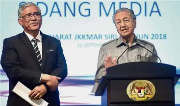  ?? — Bernama ?? Cleaning house: Dr Mahathir speaking to reporters after Cabinet committee meeting on corruption as Director- General of Governance, Integrity and Anti-Corruption Centre Tan Sri Abu Kassim Mohamed looks on.