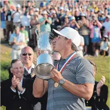  ?? ROSS KINNAIRD GETTY IMAGES ?? Brooks Koepka, 28, of Florida, kisses the U.S. Open Championsh­ip trophy after its presentati­on.
