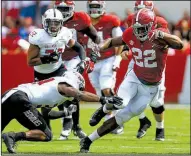  ?? AP/BUTCH DILL ?? Alabama running back Najee Harris (22) avoids a tackle attempt by Arkansas State’s Darreon Jackson during Saturday’s game. Harris rushed for 135 yards and 1 touchdown on 13 carries.