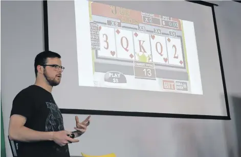  ?? KATHERINE HUNT/THE GUARDIAN ?? Reilly Webster presenting his group’s concept for a Black Jack and Slots hybrid lottery game during the Atlantic Lotto Super Hackathon held at Startup Zone over the weekend.