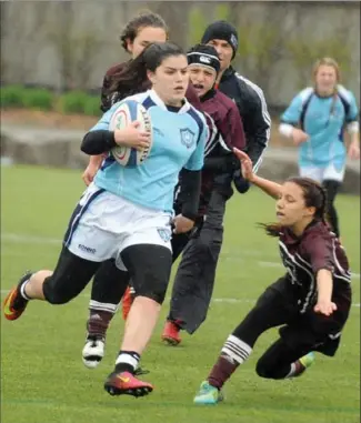  ?? DAVID BEBEE, RECORD STAFF ?? Makenna Ediss of St. Mary’s High School breaks through Niagara Falls Mustangs tacklers on her way to the game-winning try, her second of the game, on Thursday at Woodside.