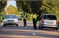  ?? ?? Polish police officers stop vehicles last week in Krynki, Poland, an area along the border with Belarus.
(AP/Czarek Sokolowski)