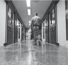  ?? Walter Michot / Miami Herald / TNS ?? A U.S. Army guard patrols a hallway in Camp 5 of the Guantanamo Bay prison in August 2012.