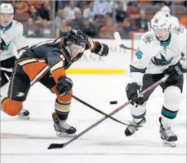  ?? Chris Carlson Associated Press ?? THE DUCKS’ Cam Fowler, left, is one of the team’s core players after signing an eight-year deal. He is shown battling the Sharks’ Jannik Hansen on Sept. 28.