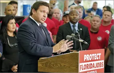  ?? AP PHOTO/CHRIS O’MEARA ?? Florida Gov. Ron DeSantis speaks to supporters and members of the media before a bill signing Thursday in Brandon, Fla. DeSantis signed a bill that protects employees and their families from coronaviru­s vaccine and mask mandates.