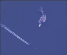  ?? CHAD FISH VIA AP ?? A fighter jet flies past the remnants of a large balloon after it was shot down above the Atlantic Ocean, just off the coast of South Carolina near Myrtle Beach, on Feb. 4.