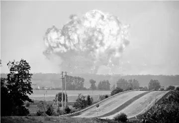  ??  ?? Smoke and flames rise over a warehouse storing ammunition for multiple rocket launcher systems at a military base in the town of Kalynivka in Vinnytsia region, Ukraine. — Reuters photo