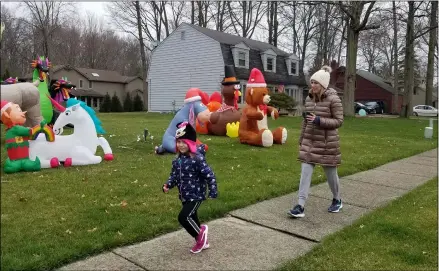  ?? JORDANA JOY — THE MORNING JOURNAL ?? Lacey, 4, left, and Kara Blackburn, 36, of Avon Lake strolled around the Landings neighborho­od as a part of a “zoofari” neighborho­od walk March 27 in Avon Lake.