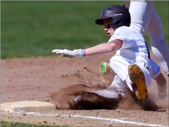  ?? JAMES THOMAS PHOTO ?? Westford Academy’s Charlie Bonenfant slides safely into third base after an Acton-boxboro wild pitch. Westford captured a tough 2-1Dual County League baseball victory on Tuesday in Westford.