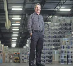  ?? CP PHOTO ?? Jim Estill, president and CEO of Danby, poses in the company’s warehouse in Guelph, Ont. on Friday. Estill is donating up to $1.5 million to support 50 Syrian refugee families in their first year of settlement.