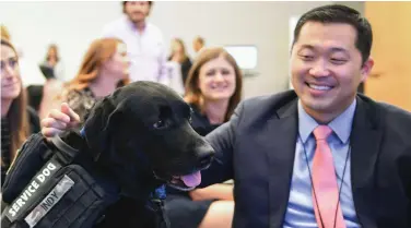  ??  ?? Jason Pak and his service dog Indy attend a Warrior Canine Connection event at Boeing’s Arlington, Virginia office.